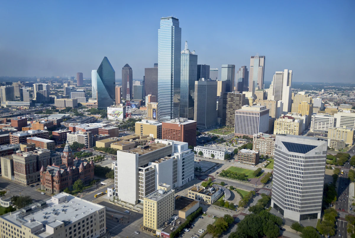 Cityscape of Dallas Texas with neon lights reflecting off glass skyscrapers
